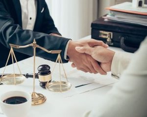 A lawyer shakes hands with his client