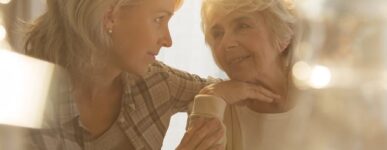 Older woman being comforted by younger woman