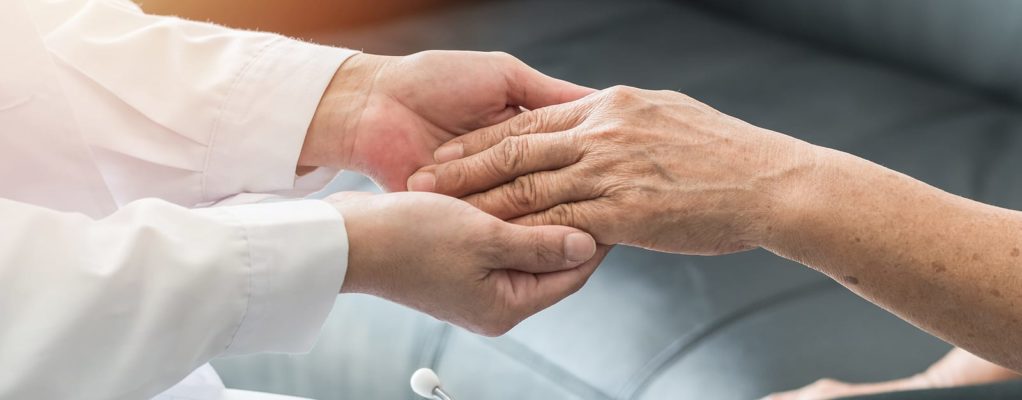 doctor holding a patients hand