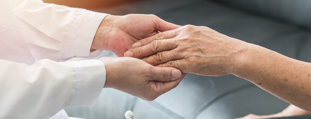 doctor holding a patients hand