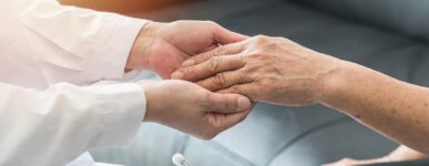 doctor holding a patients hand
