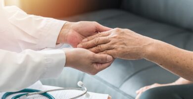 doctor holding a patients hand