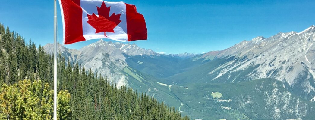 Canadian flag overlooking mountains