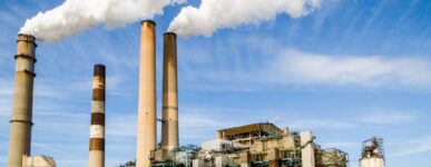 Power plant with smoke coming out of pillars