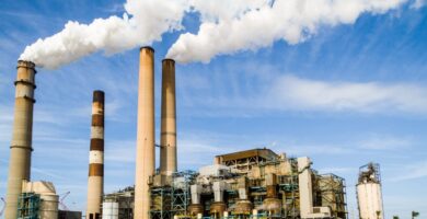 Power plant with smoke coming out of pillars