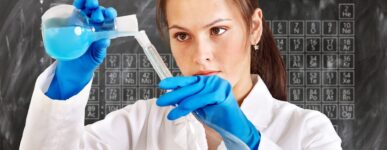 Woman chemist pouring liquid into a vial