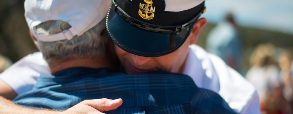 Soldier hugging an older man