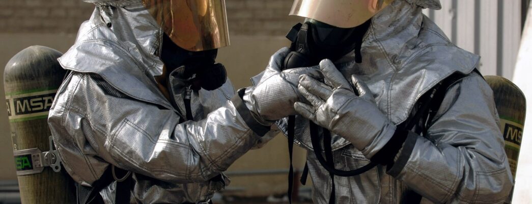 Two people in hazmat suits