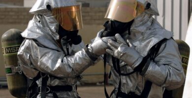 Two people in hazmat suits
