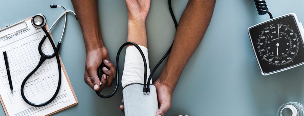 Nurse testing blood pressure of a patient