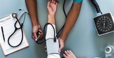 Nurse testing blood pressure of a patient