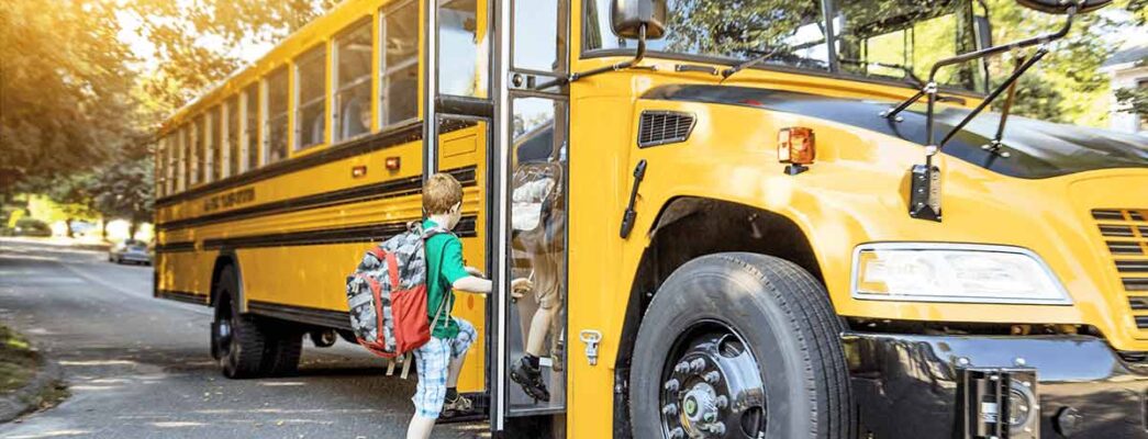 young child getting onto a school bus