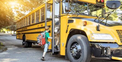 young child getting onto a school bus