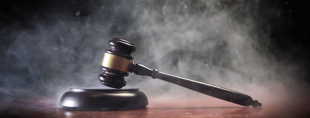 gavel sitting on a desk with smoke surrounding it