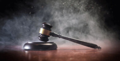 gavel sitting on a desk with smoke surrounding it