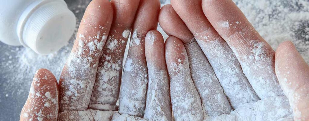close up of hands with baby powder on them
