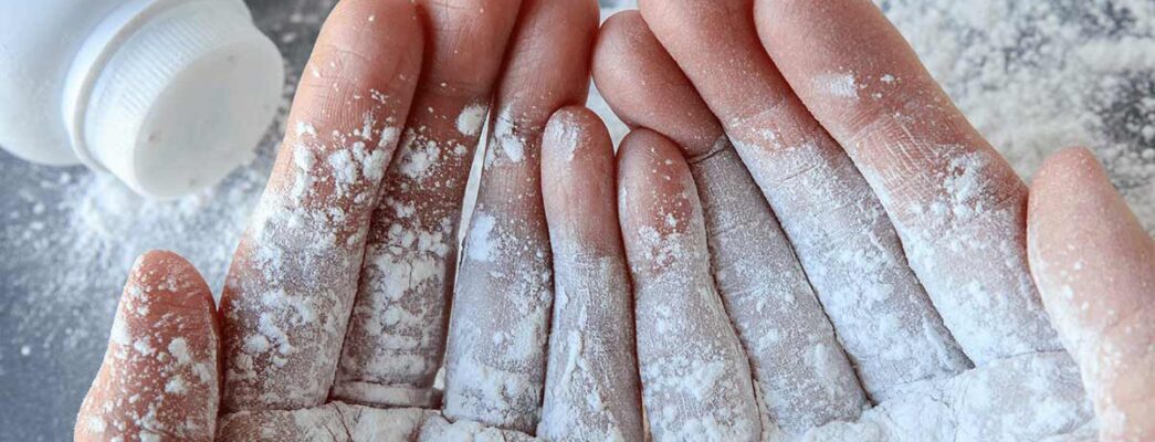 close up of hands with baby powder on them