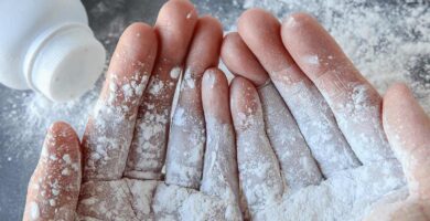close up of hands with baby powder on them
