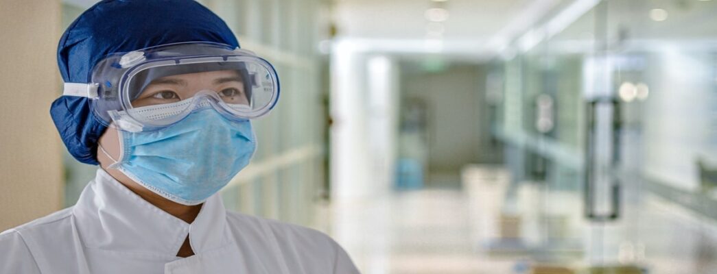 a health care worker with a face mask and goggles