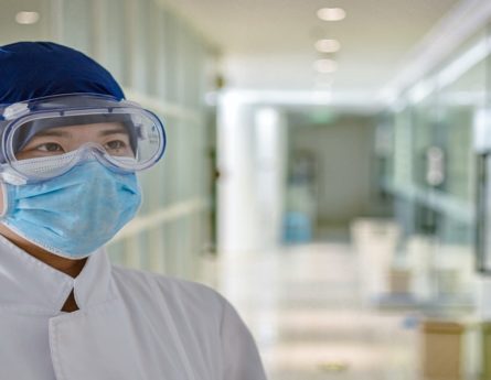 a health care worker with a face mask and goggles