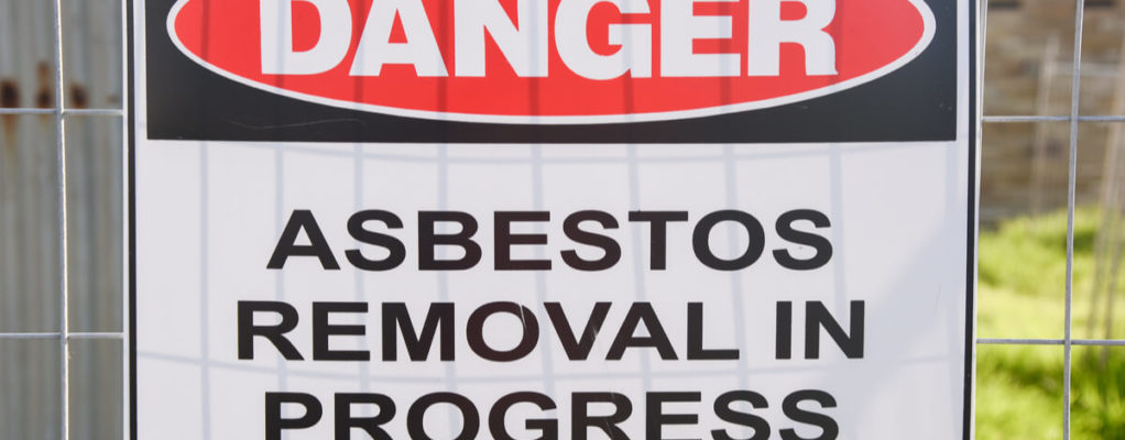 a sign warns about asbestos removal