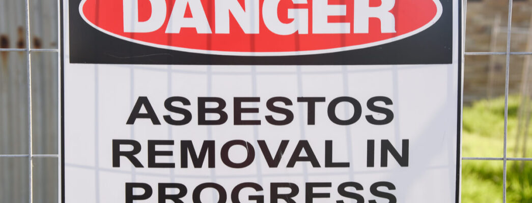 a sign warns about asbestos removal