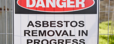 a sign warns about asbestos removal