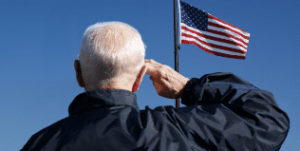 Veteran saluting the American flag