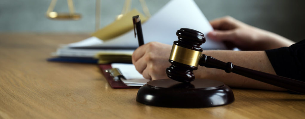 a gavel and legal documents being signed