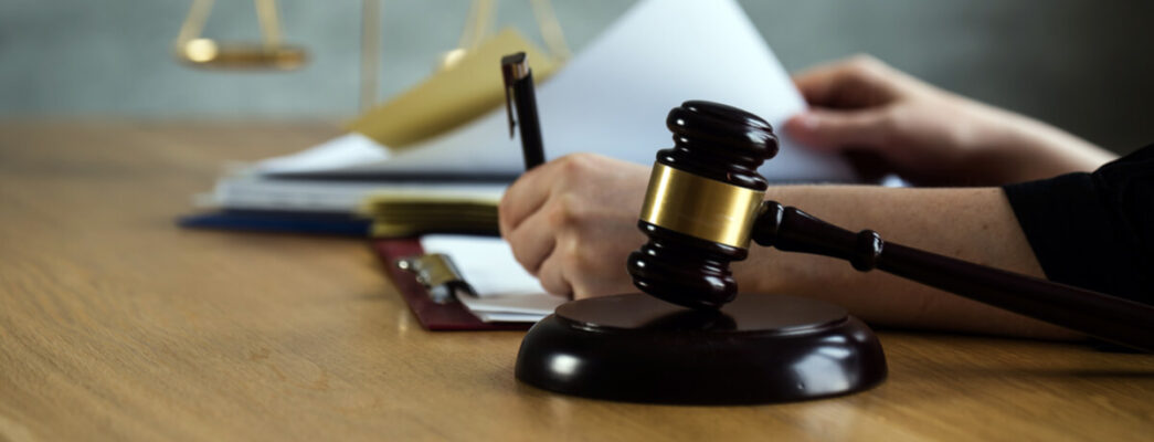 a gavel and legal documents being signed