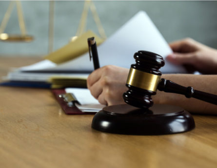 a gavel and legal documents being signed
