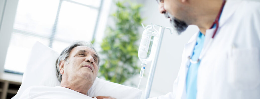 an older male cancer patient with a doctor