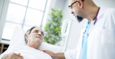an older male cancer patient with a doctor