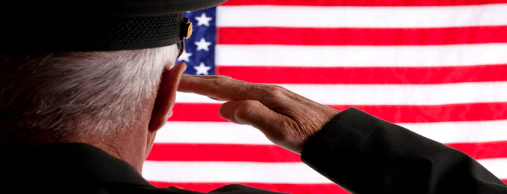 Veteran saluting American flag