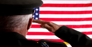 Veteran saluting American flag