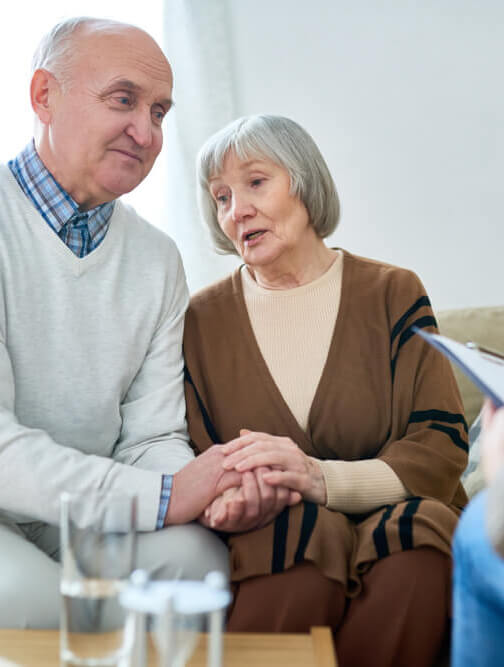 Older man consoling his wife