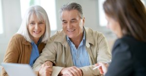 A couple meets with an insurance agent 