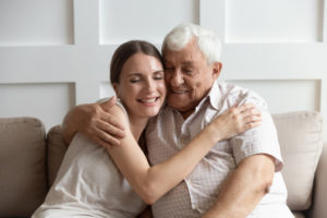 A mesothelioma patient hugs a family member