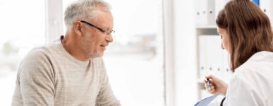 Man sitting with woman doctor