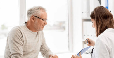 Man sitting with woman doctor