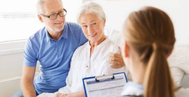 Elderly couple talking to nurse