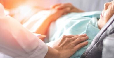 Doctor with hands on elderly patient