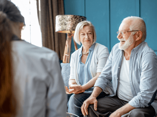 Elderly couple talking to nurse