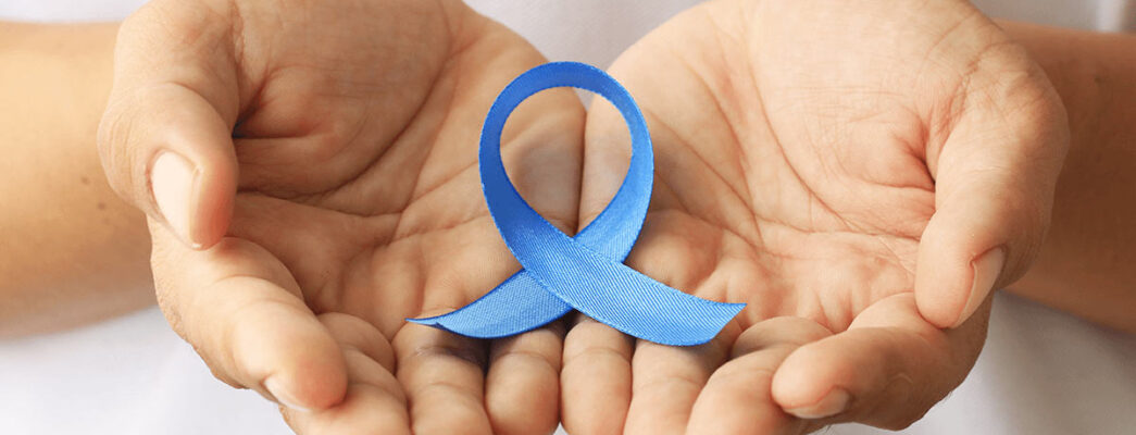 hands holding a blue awareness ribbon