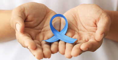 hands holding a blue awareness ribbon