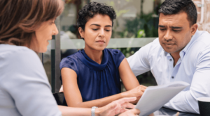 A man and a woman speaking with a lawyer about mesothelioma taxable settlements.