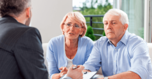 An asbestos lawyer speaks with a husband and wife