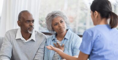 Man and woman speaking with female doctor.