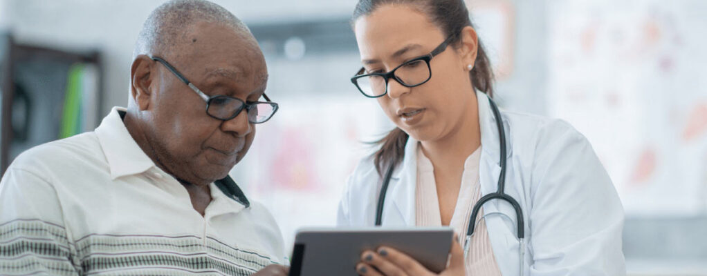 A doctor reviews information with a patient.