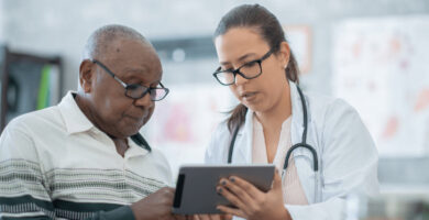 A doctor reviews information with a patient.